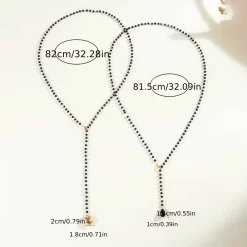 Μακρύ Κολιέ Lariat από Μαύρες Χάντρες με Χρυσή Καρδιά