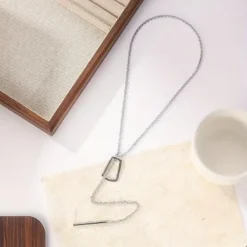 Γυναικείο minimal κολιέ Y-Lariat με ασημί αλυσίδα και γεωμετρικό στοιχείο.